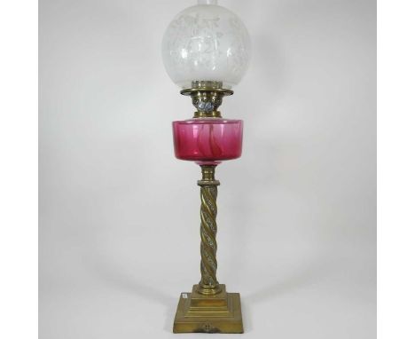 A brass oil lamp with twisted column, cranberry glass font and etched glass shade, 68cm highOverall dirty and dull. Metal bas