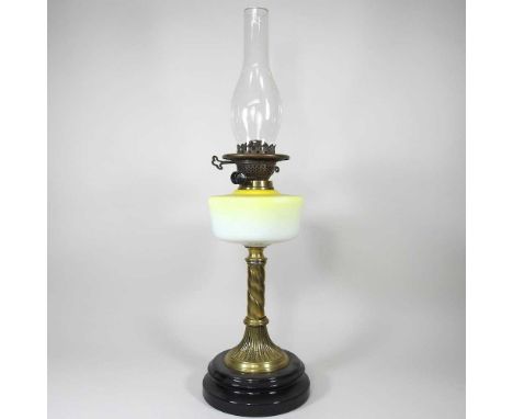 A brass and yellow glass oil lamp base, with chimney, 67cm high overall