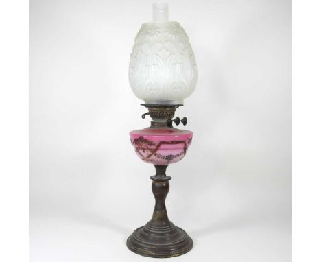 A brass and pink opaline glass oil lamp, with a moulded shade, 59 cm high overall
