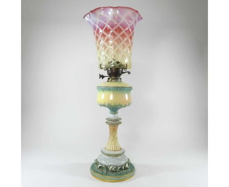 A late 19th century Royal Worcester porcelain oil lamp, shape 1964, puce printed mark, with a vaseline and pink cranberry gla