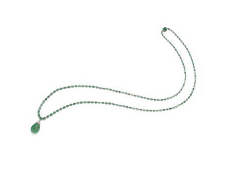 ART DECO EMERALD AND DIAMOND SAUTOIR, CIRCA 1920The long articulated chain of step-cut emeralds, suspending an emerald caboch