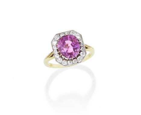 PINK SAPPHIRE AND DIAMOND RING, CIRCA 1900The oval-cut sapphire, weighing 3.89 carats, within a millegrain-set old brilliant-