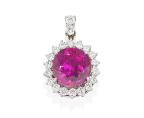 TOURMALINE AND DIAMOND CLUSTER PENDANTThe cushion-shaped pink tourmaline, weighing approximately 12.80 carats, within a surro