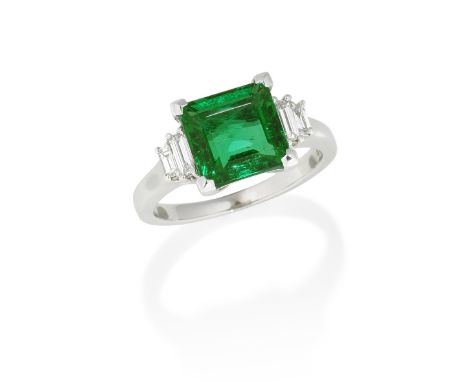 EMERALD AND DIAMOND RINGThe step-cut emerald between shoulders set with pairs of baguette-cut diamonds, mounted in white gold