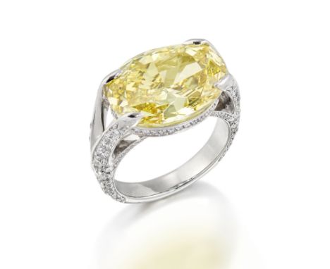 FANCY-COLOURED DIAMOND RINGThe oval-cut diamond of Fancy-Deep Yellow tint, weighing 13.64 carats, the gallery and shoulders s