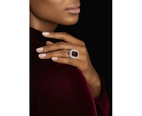TRUDEL: SPINEL AND DIAMOND RING, CIRCA 1970The step-cut spinel, stated to weigh 17.96 carats, rubover-set within a surround o
