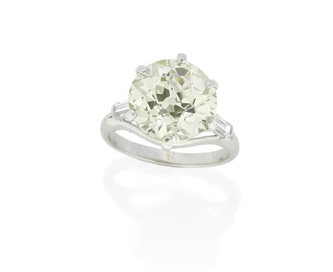 DIAMOND SINGLE-STONE RINGThe old brilliant-cut diamond, weighing 7.64 carats, between baguette-cut diamond shoulders, ring si