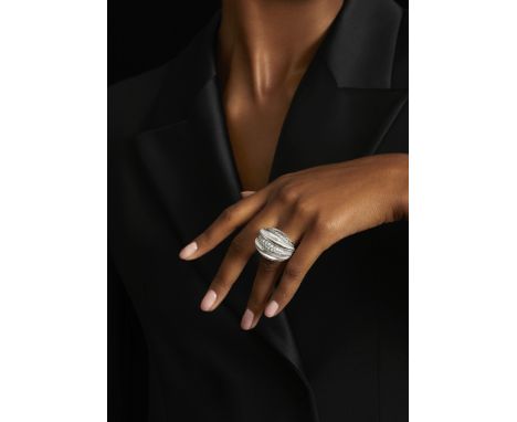 DAVID WEBB: ROCK CRYSTAL AND DIAMOND RINGOf bombé form, the carved rock crystal accented with rows of brilliant-cut diamonds,