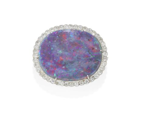 BLACK OPAL AND DIAMOND BROOCH, 1ST QUARTER OF 20TH CENTURYThe oval opal cabochon, within a surround of old brilliant-cut diam