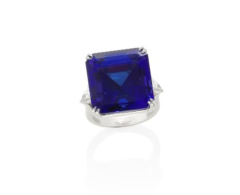 TANZANITE AND DIAMOND DRESS RINGThe step-cut tanzanite between pear-shaped diamond shoulders, tanzanite very approximately 50