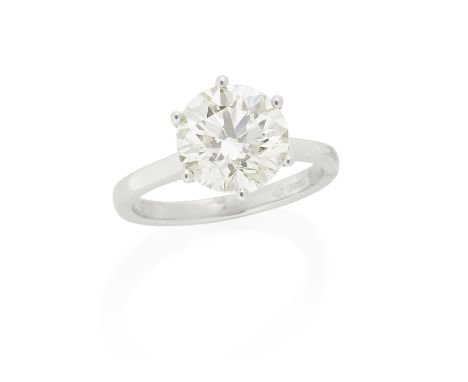 DIAMOND SINGLE-STONE RINGThe brilliant-cut diamond, weighing 3.23 carats, in a platinum setting, London hallmark, ring size L