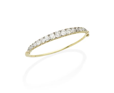 DIAMOND BANGLE, CIRCA 1880Set with a graduation of cushion-shaped and old brilliant-cut diamonds, accented by rose-cut-diamon