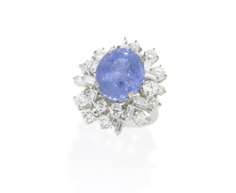 SAPPHIRE AND DIAMOND DRESS RINGThe oval-cut sapphire, weighing 12.71 carats, within a tiered and openwork surround of brillia