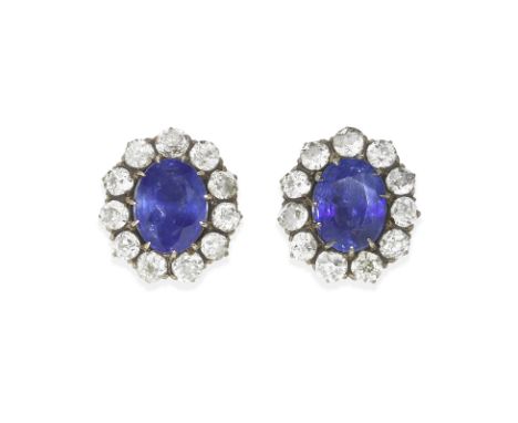 PAIR OF SAPPHIRE AND DIAMOND CLUSTER EARRINGSEach oval-cut sapphire, weighing 3.86 carats or 3.71 carats, within a surround o