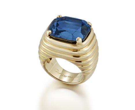 MONTURE CARTIER: SAPPHIRE RING, CIRCA 1985The cushion-shaped sapphire, weighing 22.12 carats, the ring of fluted design,  sig