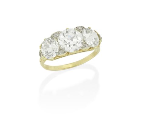 DIAMOND THREE-STONE RINGSet with old brilliant-cut diamonds, the largest at the centre, weighing 1.64 carats, within a scroll