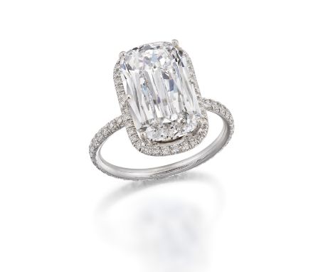 DIAMOND CLUSTER RINGThe Ashoka-cut diamond, weighing 5.02 carats, within a halo of brilliant-cut diamonds, the band set throu