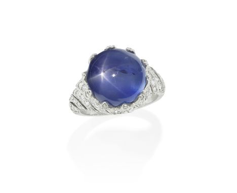 STAR SAPPHIRE AND DIAMOND RING, CIRCA 1920The star sapphire cabochon, weighing 15.90 carats, the chevron claws set with brill