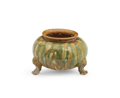 A SANCAI-GLAZED GLOBULAR TRIPOD JARTang DynastyThe vessel raised on three lion-paw legs, covered in a splashed glaze of green