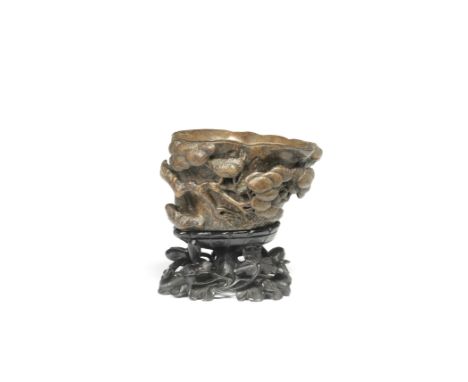 A LARGE CARVED BAMBOO 'PINE TRUNK' LIBATION CUP17th centuryThe large vessel modelled as a pine trunk section, carved in relie