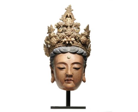 A VERY RARE MASSIVE PAINTED STUCCO HEAD OF GUANYINYuan/early Ming DynastyThe head boldly modelled as the powerful deity and b