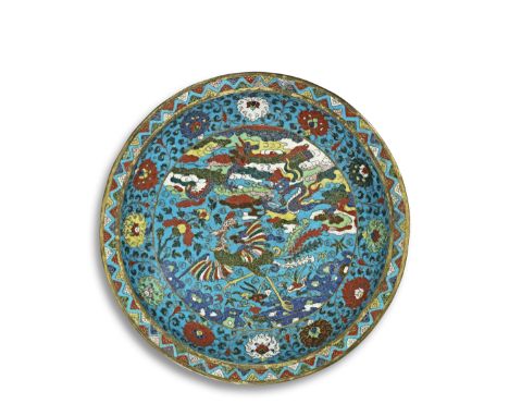 A LARGE CLOISONNÉ ENAMEL 'DRAGON AND PHOENIX' BASIN17th century The shallow circular vessel rising from a spreading foot to a