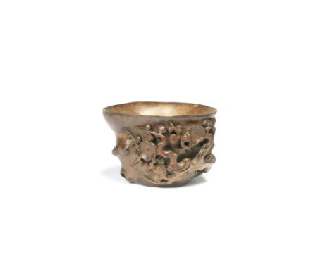 A BAMBOO 'PRUNUS' LIBATION CUP17th/18th centuryModelled as a trunk section, carved in openwork relief with gnarled blossoming