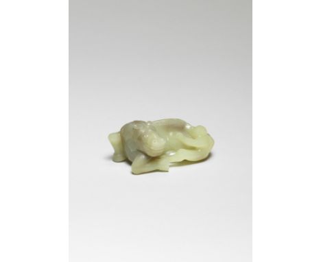 A FINE YELLOW JADE CARVING OF A HORSE AND MONKEY18th centuryCrisply carved as a recumbent horse, the head turned sharply to t