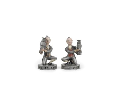 AN UNUSUAL PAIR OF PAINTED PEWTER FIGURES OF EUROPEAN TRIBUTE BEARERS18th centuryModelled in mirror image, each figure in typ