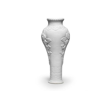 A RARE WHITE-GLAZED SOFT-PASTE SLENDER BALUSTER MOULDED VASE18th centuryThe slender body rising to a waisted neck ending in a