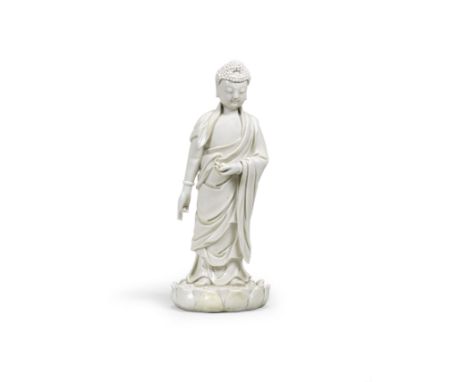 A BLANC-DE-CHINE FIGURE OF BUDDHA AMITABHALate Ming Dynasty Standing on a lotus base and wearing a long and flowing robe, tie