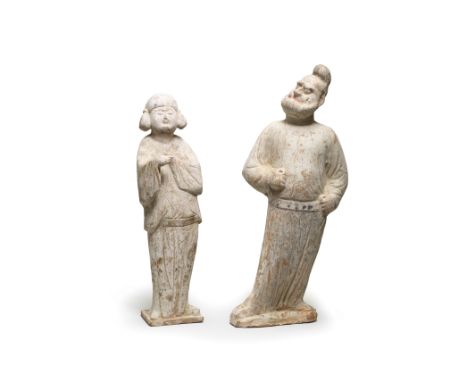 TWO PAINTED POTTERY FIGURES OF A GROOM AND A COURT LADYTang DynastyThe groom modelled with hands positioned as if holding rei