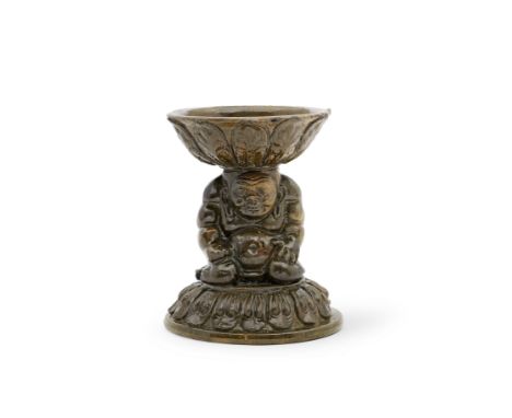 A RARE GREEN-GLAZED 'YAKSHA' LAMPNorthern Qi DynastyModelled as a muscular male figure kneeling on a domed base applied with 