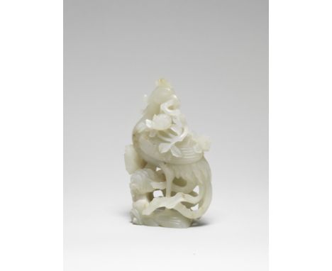 A WHITE JADE 'PHOENIX' GROUP18th century The long-tailed bird perched atop rockwork issuing lingzhi sprays, the wings neatly 