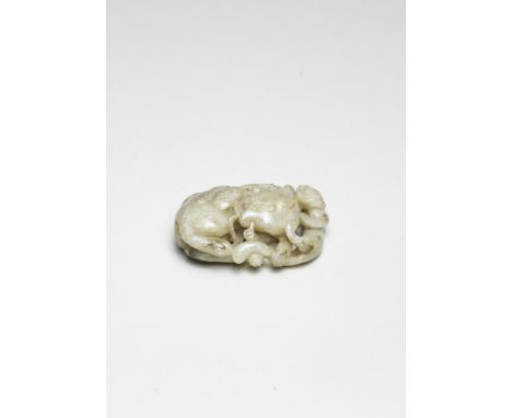 A RARE GREYISH JADE CARVING OF A MYTHICAL BEAST AND YOUNG16th centuryThe oval pebble finely carved and pierced as a recumbent