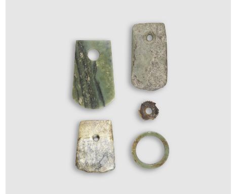 FIVE ARCHAIC JADE AND HARDSTONE CARVINGSNeolithic Period to Shang DynastyComprising a green and black jade axe blade, Neolith