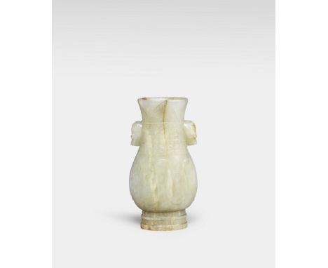 AN ARCHAISTIC PALE GREEN AND RUSSET JADE VASE, HUYuan/Ming DynastyThe body carved in low relief with lappets, the neck with a