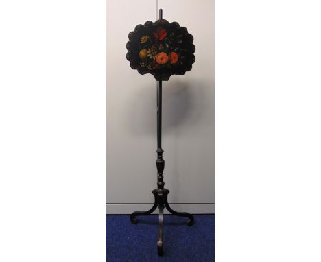 A Victorian papier mâché fire screen decorated with flowers and leaves, the cylindrical stand on three scroll supports, 137cm