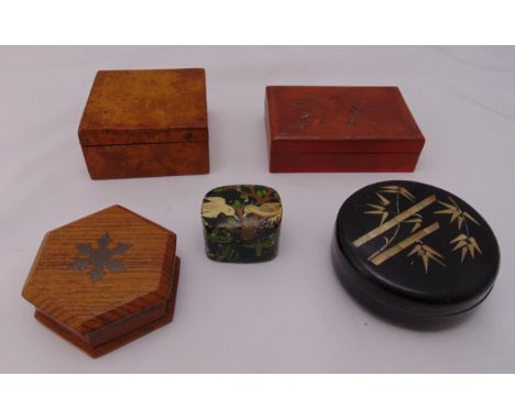 A quantity of boxes to include an ebonised circular box with mother of pearl inlays, a papier mache box and three wooden boxe