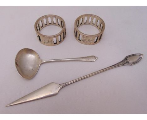 A quantity of hallmarked silver and white metal to include napkin rings and a ladle, approx total weight 110g