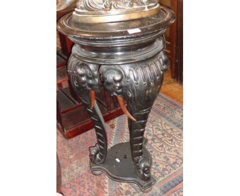 Victorian carved and ebonised wood plant stand having elephant trunk supports