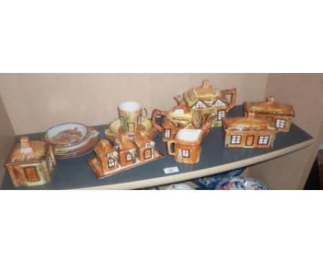 Price of Kensington pottery Cottage ware, including teapots, cruet set, butter dishes and others