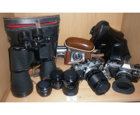 Two Olympus SLR cameras with lenses, another camera and a pair of Prinz binoculars and filters