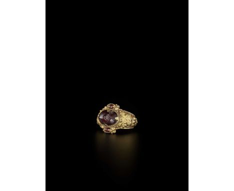 Champa, 10th-13th century. The richly decorated ring set with an oval garnet at the top and two small amethysts flanking the 