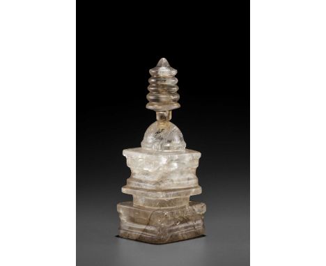 Laos, 15th-16th century. The translucent stone with natural light and dark inclusions, the base, mid-section, and finial carv