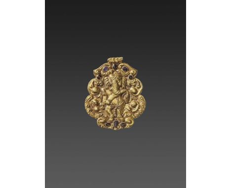 Champa, 10th-12th century. The richly decorated pendant with fine repoussé depicting Ganesha dancing surrounded by scrolling 