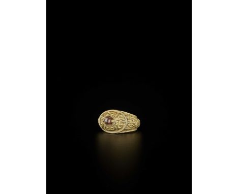 Champa, 10th-12th century. The ring set with an oval agate at the top, surrounded by scroll designs executed in repoussé, the