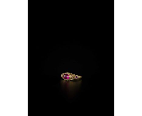 Burma, 19th century. The ring top set with a large oval ruby, the shoulder set with two smaller round rubies surrounded by fi