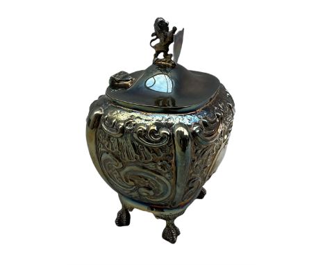 Edwardian silver tea caddy with lion and shield shape lift, embossed decoration with vacant cartouche and on claw and ball fe