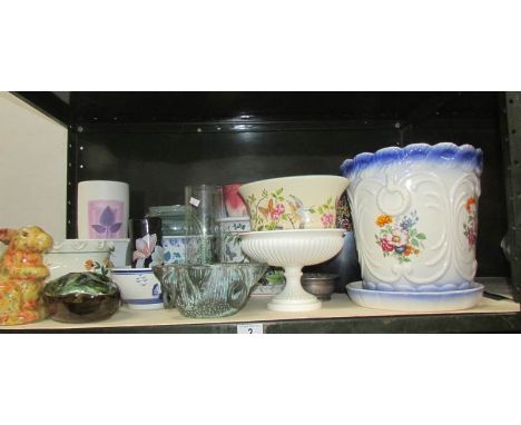 A shelf of plant pots, vases etc.,